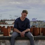 man sitting on roof deck