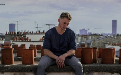 man sitting on roof deck