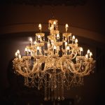 brass uplight chandelier turned on in room